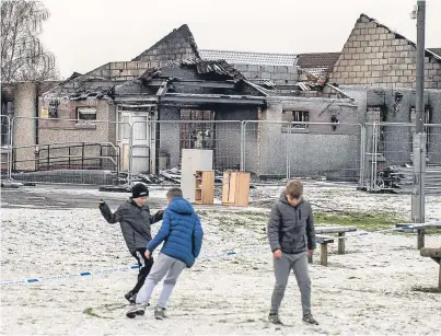  ?? Picture: Wullie Marr. ?? Youngsters play in front of the school which was devastated by fire last week.