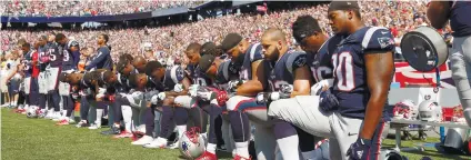  ?? AP FOTO ?? POLITICAL. Some members of the New England Patriots kneel during the playing of the US anthem.