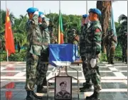  ?? YANG ZURONG / XINHUA ?? Blue berets salute during the funeral of Shen Liangliang, who was killed in Mali last year.