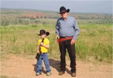  ?? Photo courtesy of the Reeves family ?? ■ Raymond Reeves and his grandson Truman Reevesmith pictured on the family’s Donley County ranch in the early 2000s.