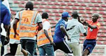  ??  ?? A referee being chased by fans after violence erupted at a league match