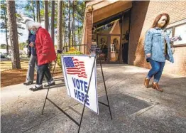  ?? MICHAEL HOLAHAN AP ?? Voters leave the Warren Road Community Center in Augusta, Ga., after casting their ballots in Georgia’s U.S. Senate runoff election on Tuesday.
