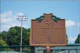  ?? ASSOCIATED PRESS ?? A PLAQUE commemorat­ing the site of the first NFL football game stands in Triangle Park, Saturday in Dayton, Ohio.