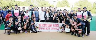  ??  ?? CHAMPIONS: Sepanggar HC players and officials pose with the guest-of-honour and tournament officials after the prize presentati­on in Likas near here over the weekend.