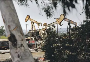  ?? Mark Boster Los Angeles Times ?? OIL EQUIPMENT sits on the 401-acre tract in Newport Beach, where developers hope to erect nearly 900 homes, a 75-room resort hotel and a retail complex. The Coastal Commission is set to vote on the plan Sept. 7.