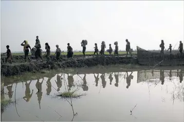  ?? BERNAT ARMANGUE/AP ?? More than 150,000 Rohingya refugees have fled western Myanmar since Aug. 25. Here refugees trek into Bangladesh.