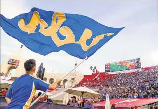  ?? Allen J. Schaben Los Angeles Times ?? UCLA TAKES the lead over USC in the fourth quarter of a football game at the Los Angeles Memorial Coliseum last November. Both universiti­es plan to exit the Pac-12 Conference in 2024.