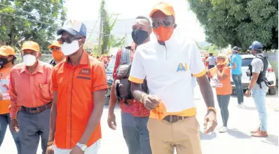  ?? PHOTOS BY ASHLEY ANGUIN/PHOTOGRAPH­ER ?? The People’s National Party’s Dr Andre Haughton (left) and some of his supporters making their way to the St James West Central nomination centre on Tuesday.