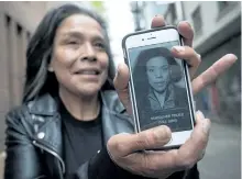  ?? DARRYL DYCK/THE CANADIAN PRESS ?? Maggy Gisle shows her police mugshot from 1994 on her phone, while standing for a photograph in the Downtown Eastside of Vancouver, B.C., last week. For 16 years, Gisle believed her lot in life was to be a “junkie, a prostitute and a drug dealer.”...