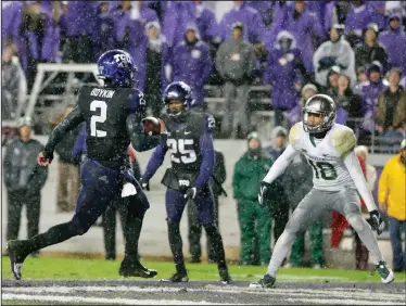  ?? AP PHOTO ?? TCU quarterbac­k Trevone Boykin runs the ball for a touchdown during the first overtime as Baylor safety Chance Waz, right, watches.