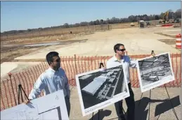  ??  ?? Wan Lovichit (left) and Adam Markward show renderings for the forthcomin­g Bayer CropScienc­e greenhouse and research-and- developmen­t facilities.