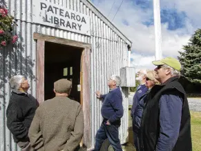  ?? PHOTO: SUPPLIED ?? A Maniototo gem . . . West Otago tourists David Roberts, Peter McPherson, George Redditt, Dave Adams, Diane Bell and Roger Bell, impressed by the Patearoa Library on a St Patrick’s Day visit on Sunday.