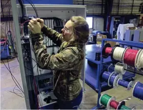  ?? JOURNAL SENTINEL ?? Amber Ferry wires a control unit for an oven last month at Wisconsin Oven Corp. in East Troy. MICHAEL SEARS/MILWAUKEE