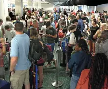  ?? Reuters ?? Passengers form a long queue at Orlando Internatio­nal Airport before Hurricane Irma makes landfall