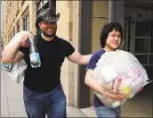  ?? KIICHIRO SATO - THE ASSOCIATED PRESS ?? Amos Yee, right, a teenage blogger from Singapore, leaves a U.S. Immigratio­n and Customs Enforcemen­t office in Chicago with his friend Adam Lowisz on Tuesday.