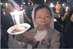  ?? AFP ?? A nun joins a vigil in Denpasar, Bali, on Thursday night to show moral support for the jailed Jakarta mayor Basuki Tjahaja Purnama.