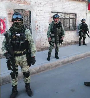  ??  ?? Soldiers patrol a neighbourh­ood in Irapuato, Guanajuato state, Mexico. Mexico’s drug war has long played out in northern border cities, and now residents have to deal with the coronaviru­s outbreak as well.