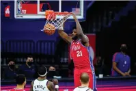  ?? The Associated Press ?? Philadelph­ia 76ers’ Joel Embiid dunks the ball during the second half of Wednesday’s game against the Utah Jazz in Philadelph­ia.
