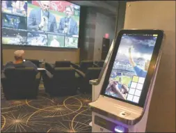  ?? The Sentinel-Record/Grace Brown ?? PLACING BETS: One of the wagering kiosks at Oaklawn Racing Casino Resort’s new Race & Sports Book, which opened Monday. The addition makes Arkansas the ninth state in the country to offer sports wagering, according to the American Gaming Associatio­n.