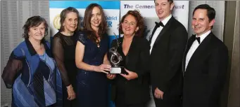  ??  ?? The Highlanes Team accept the Sport, Art and Culture Award from Helen Bennett from Irish Cement.