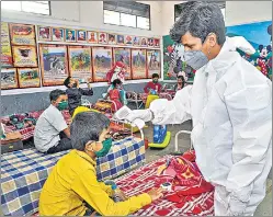  ?? PTI ?? A medic conducts thermal screening of a child admitted at a Covid centre, in Sangli on Friday.