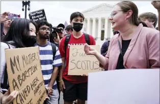  ?? JACQUELYN MARTIN — THE ASSOCIATED PRESS ?? Abortion-rights activists, left, confront pro-life activists following Supreme Court’s decision to overturn Roe v. Wade in Washington on Friday. A decision by its conservati­ve majority overturned the court’s landmark abortion cases.