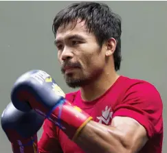  ??  ?? Pacquiao attends a training session at the Venetian Macao hotel in Macau in this file photo. — Reuters photo