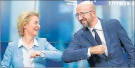  ?? AFP ?? DEAL DONE! European Commission president Ursula Von Der Leyen (left) and European Council chief n
Charles Michel bump elbows after a press conference following the marathon EU summit in Brussels.