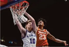  ?? Charlie Riedel/Associated Press ?? Kansas’ Johnny Furphy, left, scored 16 points, nine of them from the free-throw line, and added eight rebounds in the Jayhawks’ 86-67 win over Texas.