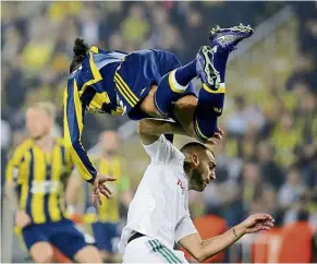  ?? — AP ?? Flying start: Fenerbahce’s Bruno Alves jumps over Lokomotiv Moscow’s Petar skuletic during their europa League first leg last-32 match in Istanbul on Tuesday. Fenerbahce won 2-0.