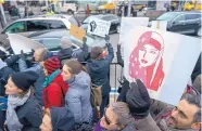  ?? CRAIG RUTTLE/ASSOCIATED PRESS ?? Protesters assemble at John F. Kennedy Internatio­nal Airport in New York Saturday after two Iraqi refugees were detained trying to enter the country.