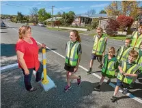  ?? PHOTO: MYTCHALL BRANSGROVE/FAIRFAX NZ ?? Highfield Primary School teacher Robyn Cooper watches a group of year 8 leaders and juniors cross Puriri St.