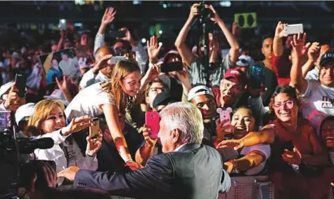  ?? AP ?? Supporters of presidenti­al candidate Andres Manuel Lopez Obrador, of the Morena party, greet him as he arrives for his closing campaign rally at Azteca stadium in Mexico City, on Wednesday. Mexicans will elect a new president today.