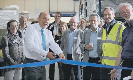  ?? ?? MP Andrew Griffith cuts the ribbon to formally open Hepworth’s new warehouse, an ongoing project since 2019