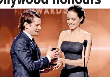  ??  ?? O’Connell accepts the New Hollywood Award for ‘Unbroken’ from Jolie onstage during the 18th Annual Hollywood Film Awards at The Palladium on Friday in Hollywood, California. (Clockwise from top left) Cumberbatc­h accepts the Hollywood Actor Award for...