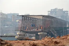  ?? AFP ?? The Old Metal bridge being repaired in Mosul. Iraq needs to raise $100 billion to rebuild, Prime Minister Haider Al Abadi has said, after decades of sanctions and war. —