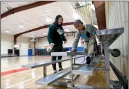  ?? NWA Democrat-Gazette/ANDY SHUPE ?? Ellis Stevenson (right), 6, helps volunteer Cindy Mao on Friday as they clean the bleachers in the Yvonne Richardson Community Center in Fayettevil­le. City staff completed a lighting and insulation upgrade for the center in 2015 that included LED...