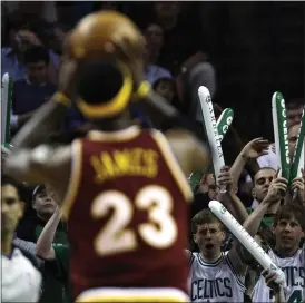  ?? CHARLES KRUPA — THE ASSOCIATED PRESS ?? Celtics fans try to distract LeBron James while he shoots foul shots during the first quarter of Game 3of a 2010second-round NBA playoff series in Boston.