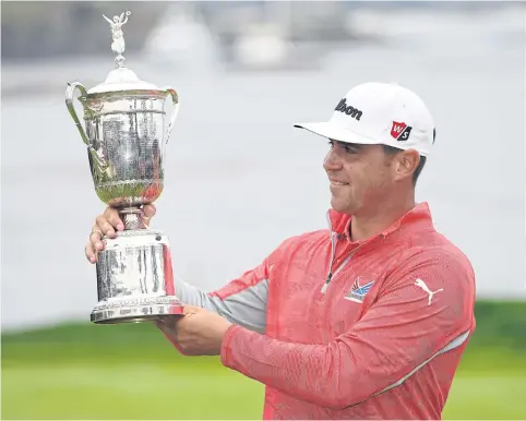  ?? AFP ?? Gary Woodland holds the trophy after winning the US Open at Pebble Beach on Sunday.