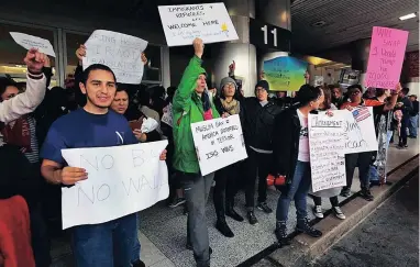  ?? PICTURE: AP ?? DEFIANT WELCOME: Protesters oppose US President Donald Trump’s refugee ban at Miami Internatio­nal Airport on Sunday.