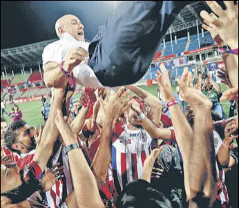  ??  ?? ATK coach Antonio Lopez Habas is hoisted by players after they won the Indian Super League final against Chennaiyin FC on Saturday.