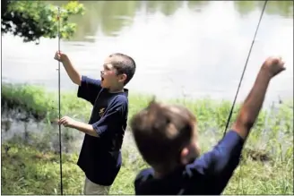  ?? KYLE KURLICK/SPECIAL TO THE COMMERCIAL APPEAL ?? Ben Hale and his fellow Royal Ambassador­s from Faith Baptist Church try their hand at fishing during a summer play day at Red Oak Lake campground in Cordova.