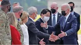 ?? (AFP) ?? Japan’s FM Yoshimasa Hayashi (centre) and US Ambassador to Japan Rahm Emanuel (centre-left) greet US President Joe Biden (second from right) at Yokota Air Base in Fussa, Tokyo prefecture on Sunday
