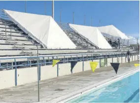  ??  ?? Tents being pulled down at the National Aquatic Centre following the cancellati­on of the practice session on Saturday.