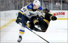  ?? MICHAEL DWYER — THE ASSOCIATED PRESS ?? St. Louis’ Ivan Barbashev, left, checks Boston’s Chris Wagner during the first period on Saturday.