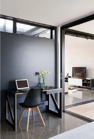  ??  ?? DECOR The home’s neutral colour scheme is accented by bold black walls, tiles and fittings. Timber provides warmth and shades of blue add a dash of cool coastal colour.