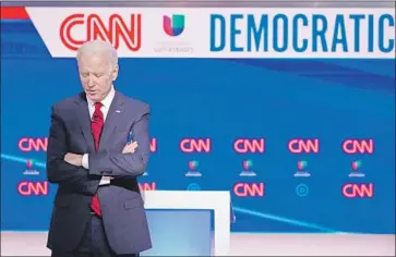  ?? Mandel Ngan AFP/Getty Images ?? JOE BIDEN, seen at his debate with Bernie Sanders on March 15, appears to have a secure lead in delegates. But things won’t be settled soon, as nearly a dozen states have postponed voting due to the pandemic.