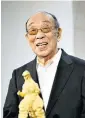  ??  ?? Nakajima with a gold statue of Godzilla at a Tokyo exhibition