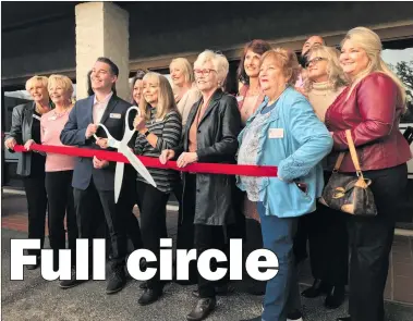  ?? Austin Dave/The Signal ?? A group of Circle of Hope officials and guests get ready to cut the ribbon at the organizati­on’s new center, located at 23033 Lyons Ave. in Newhall. The organizati­on provides financial and emotional help for cancer patients.