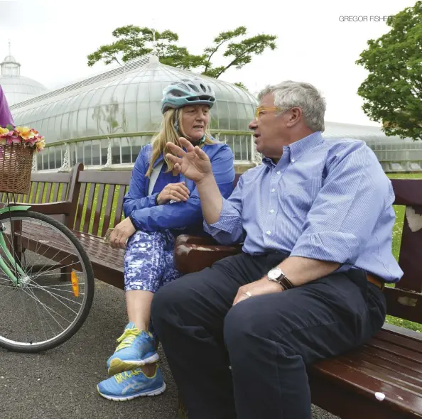  ??  ?? Above and left: Gregor gets on his bike with Claire Robertson (left) and Liz Kenny from cycling charity Free Wheel North at Glasgow Botanic Gardens.